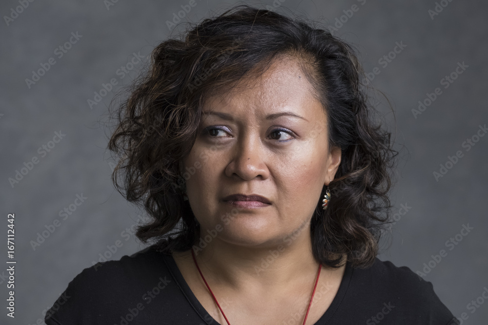 An Asian woman with a troubled face An Asian woman with a troubled face