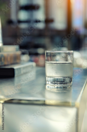 Water in glass on bar background