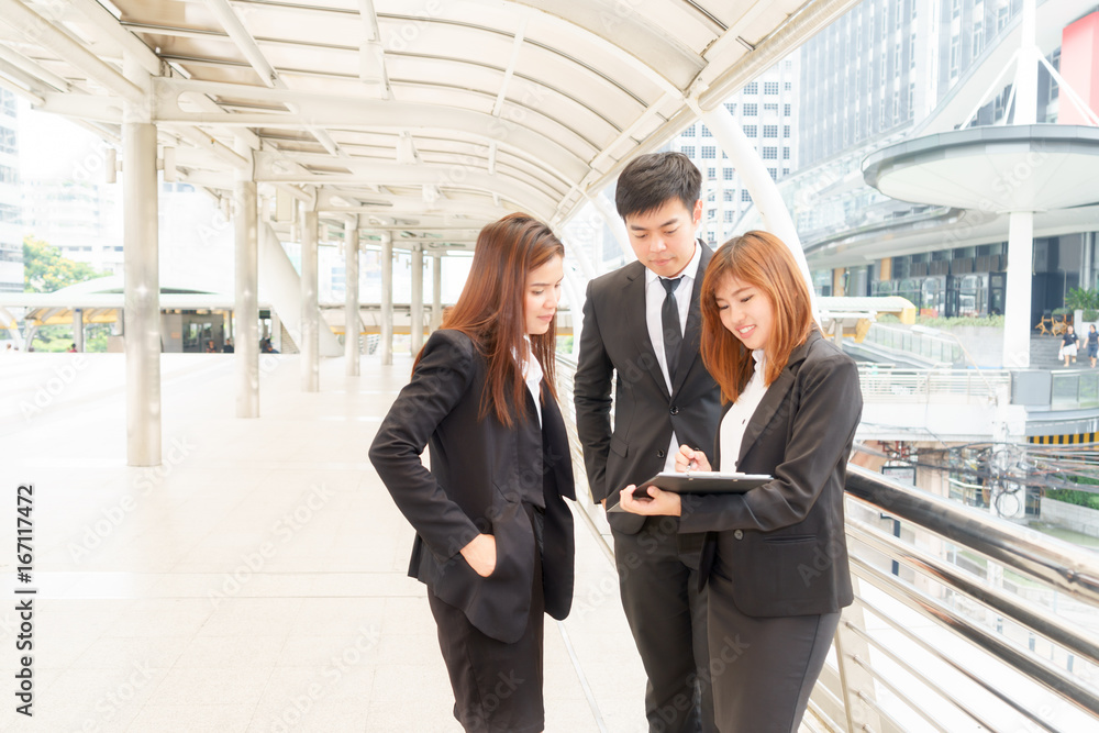 Fototapeta premium Smiled businesswoman and businessman standing outside office and talking to each other.