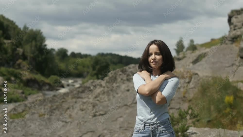 Girl standing in sunlight on landscape Girl standing in sunlight on landscape