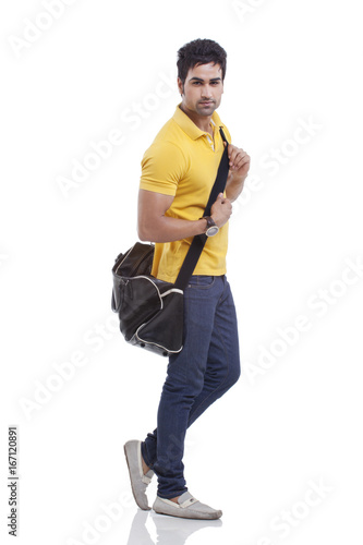 Fototapeta Naklejka Na Ścianę i Meble -  Portrait of handsome young man with duffel bag 