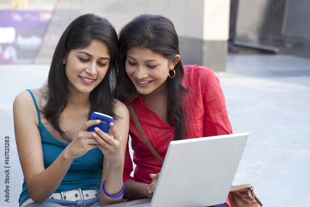 Beautiful young women using cell phone Beautiful young women using cell phone