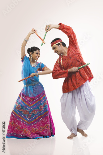 Gujarati couple performing dandiya  photo