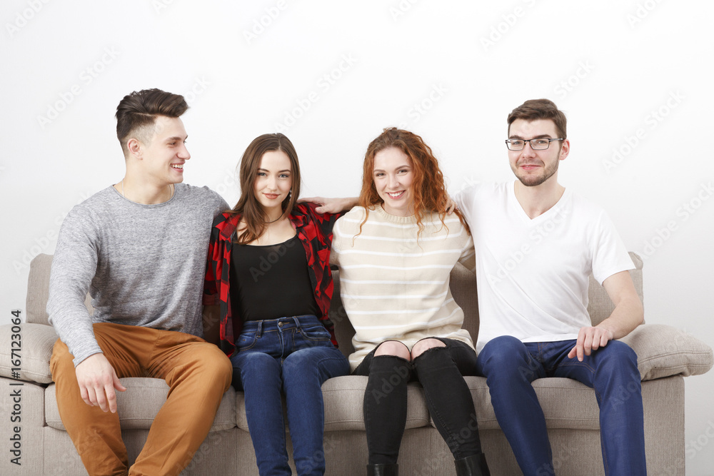 Happy young friends, casual people sitting on couch Happy young friends, casual people sitting on couch
