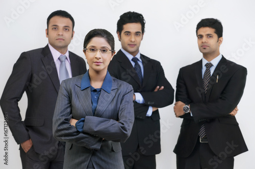 Group portrait of confident business people standing against gray background 