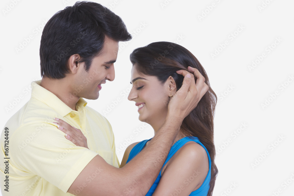 Side view of romantic young couple isolated on white background Side view of romantic young couple isolated on white background