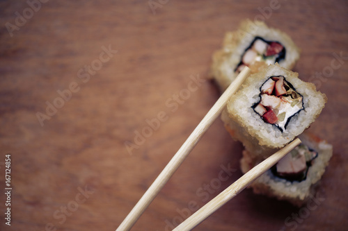 Фотография Japanese sushi rolls on a wooden stand. Japanese food.