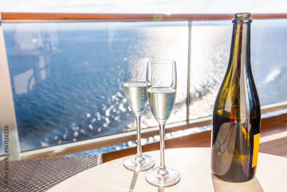 Champagne bottle and flutes glasses on luxury cruise travel for honeymoon  holidays. Boat at sea on vacation sunset with celebration drinks. Stock  Photo | Adobe Stock