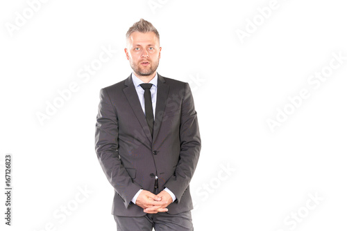 Portrait of middle-aged businessman in elegant suit posing against white background