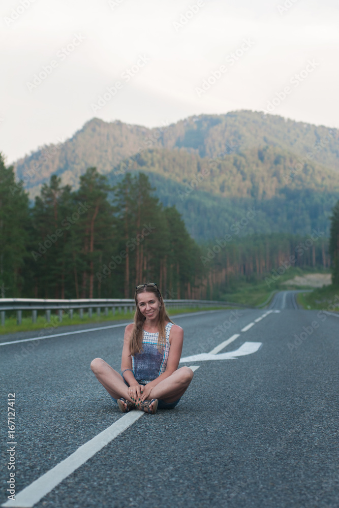 Woman sitting on the road