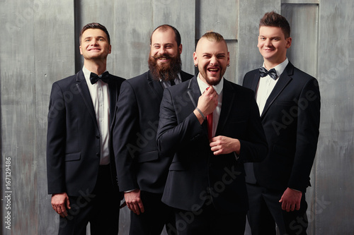 Tableau sur toile Group of handsome elegant young men in tuxedo.