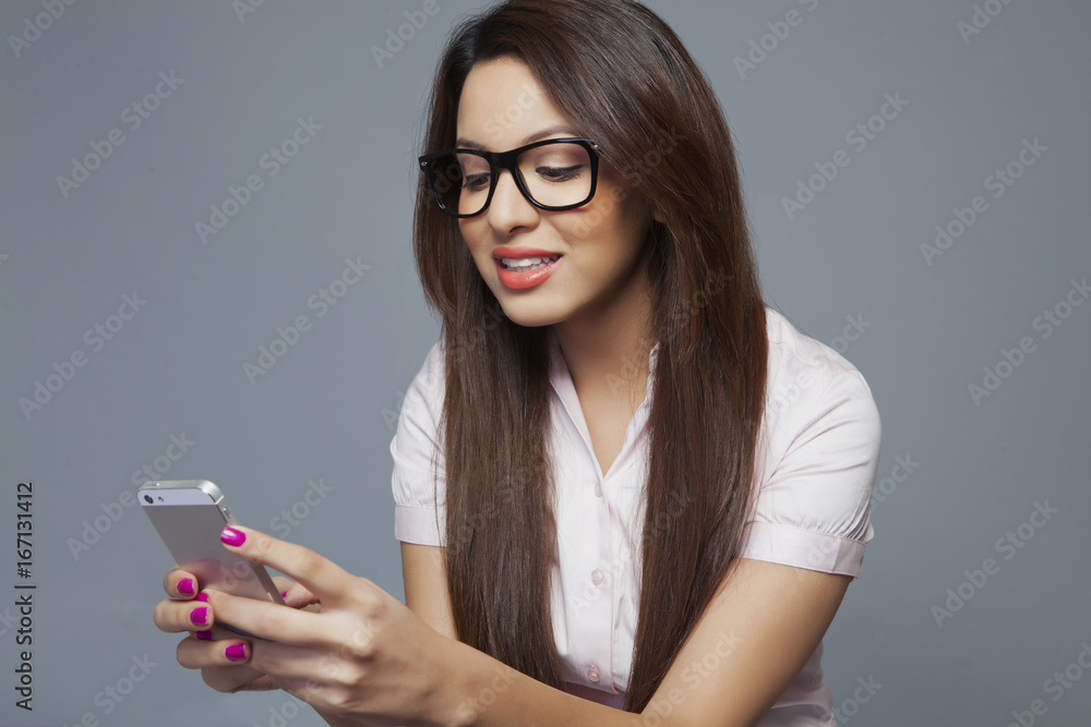 Female executive reading an sms on mobile phone