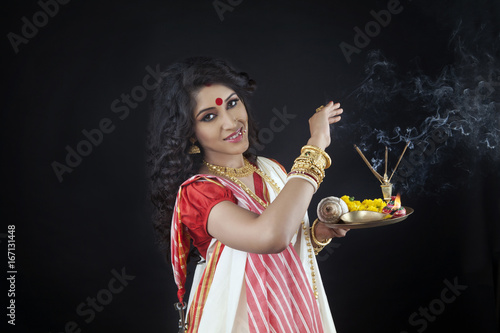 Portrait of Bengali woman holding a puja thali photo