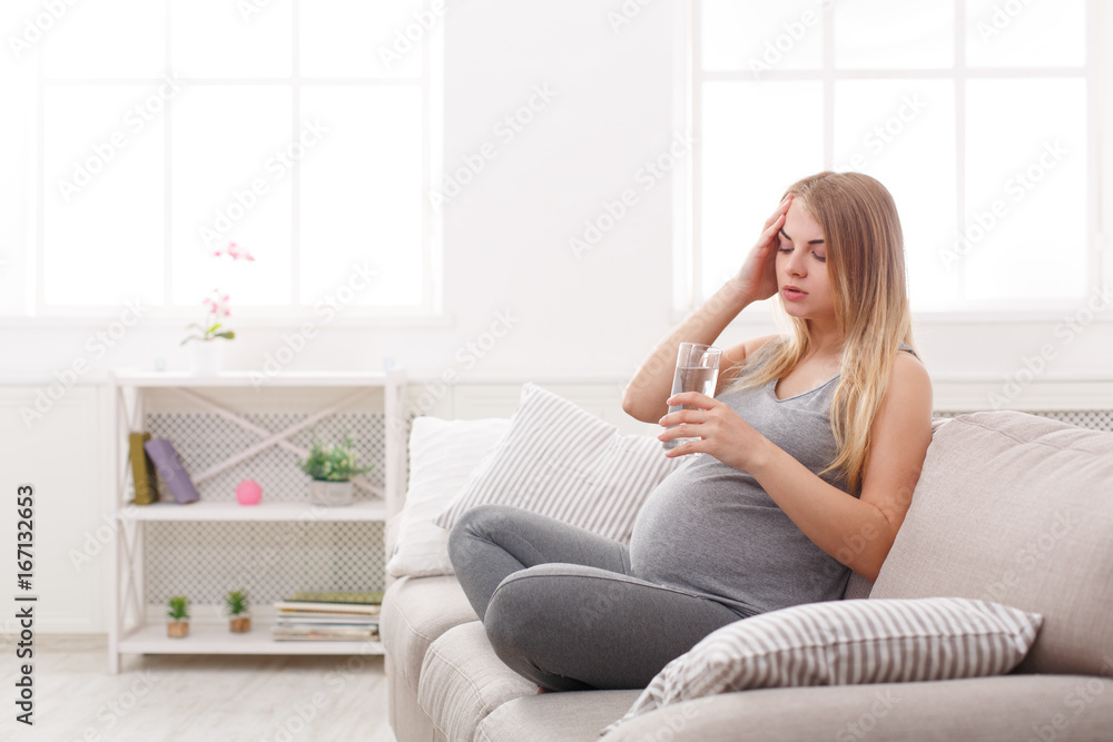 Young expectant blonde with headache copy space Young expectant blonde with headache copy space