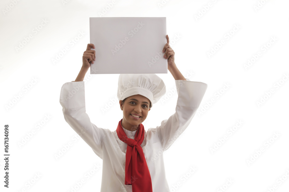 Portrait of female chef holding blank placard isolated over white background Portrait of female chef holding blank placard isolated over white background