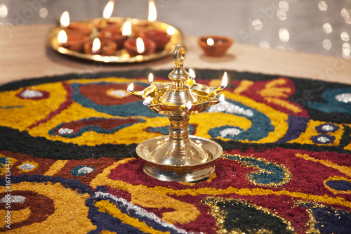 Close-up of rangoli with diyas photo