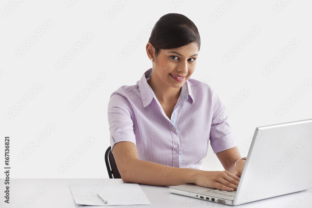 Portrait of female executive working on laptop Portrait of female executive working on laptop