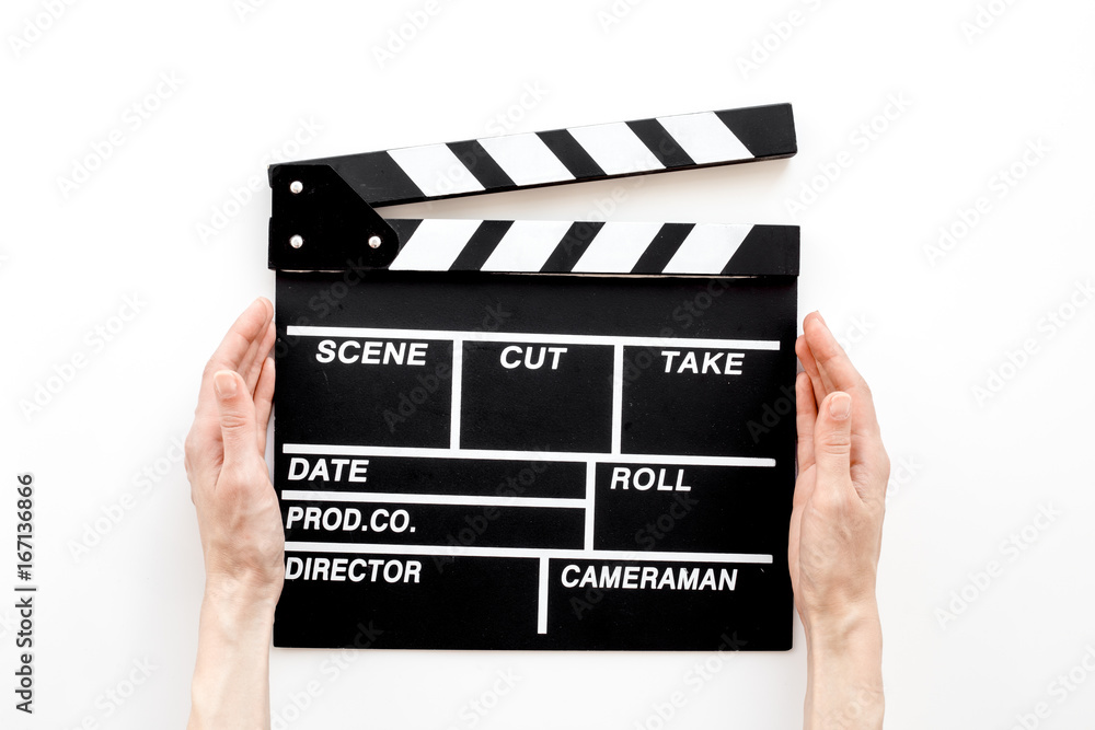 Filmmaker profession. Clapperboard on white background top view