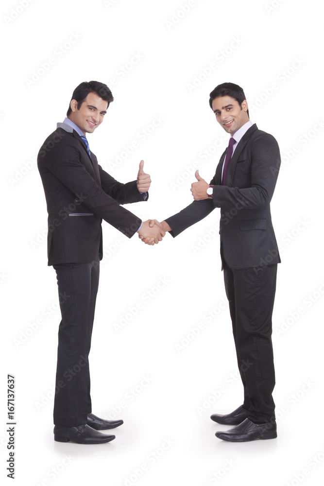 Portrait of two businessmen giving thumbs up Portrait of two businessmen giving thumbs up