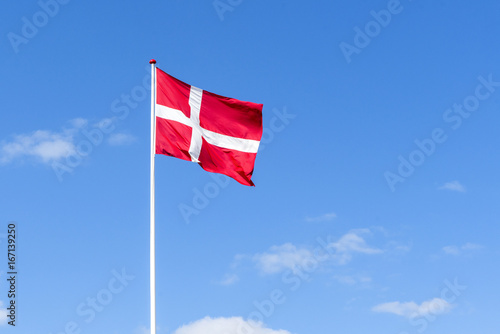 The danish flag in red and white waving in the wind photo