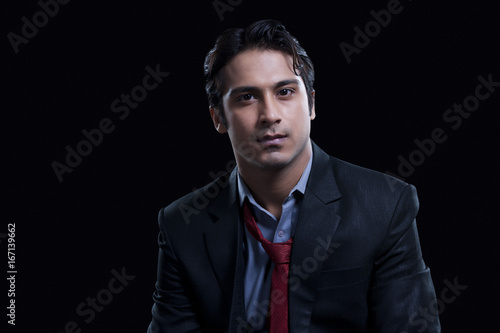Handsome businessman over black background © IndiaPix