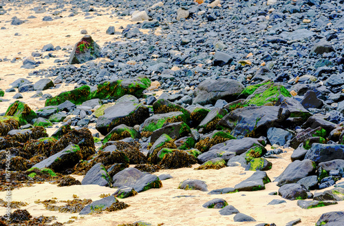 Large rocks on a beach in Cornwall in the summertime, around mid day.