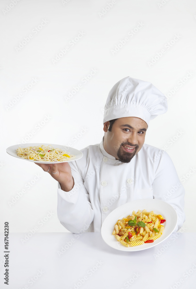 Portrait of chef holding plates with pasta Portrait of chef holding plates with pasta