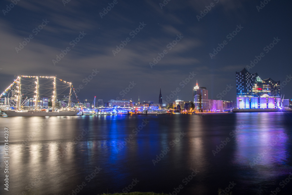 Hamburg, Germany, Panorama of the Harbour at night. With the colored illuminated music hall at Christopher Street Day Hamburg, Germany, Panorama of the Harbour at night. With the colored illuminated music hall at Christopher Street Day