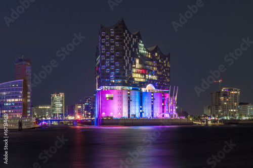 Hamburg, Germany, Panorama of the Harbour at night. With the colored illuminated music hall at Christopher Street Day photo