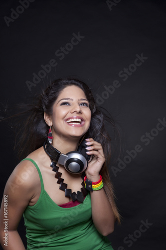 Young woman holding headphones