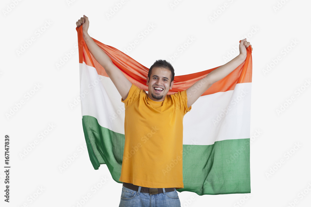 Portrait of happy young man in casual wear holding out Indian flag over white  background Stock Photo | Adobe Stock