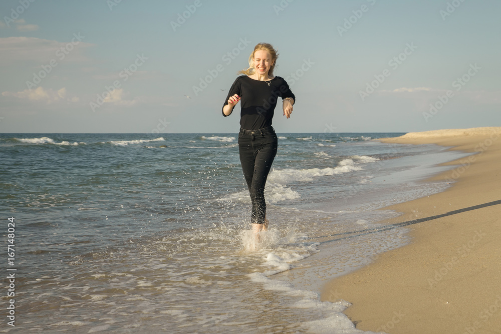 happy blond woman running at sunny sea beach smiling happy blond woman running at sunny sea beach smiling