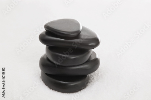 Stacked massage stones on a towel 