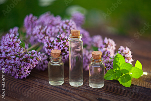 Essence of lavender flowers on table in beautiful glass Bottle