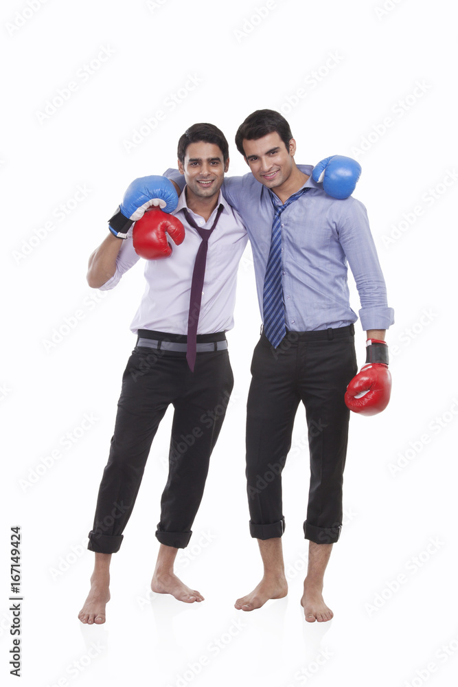 Portrait of two male executives with boxing gloves Portrait of two male executives with boxing gloves