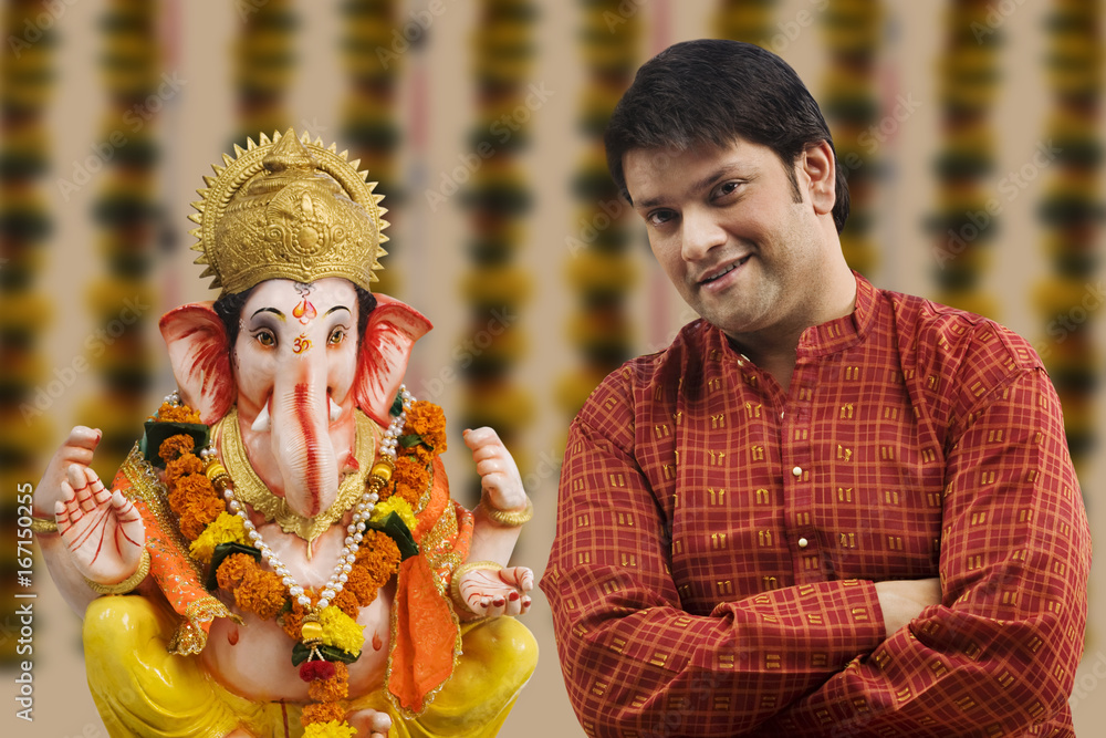 Portrait of a man with a Ganesh idol Portrait of a man with a Ganesh idol