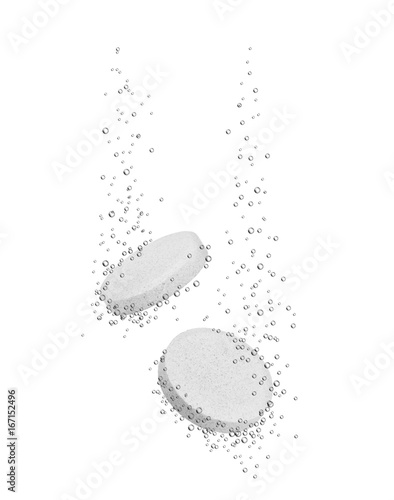 Medical pills dissolves in water on white background photo