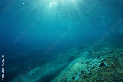 Natural sunlight underwater through water surface in the Mediterranean sea on a rocky seabed, Catalonia, Roses, Costa Brava, Spain