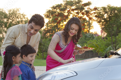 Woman putting tika on new car