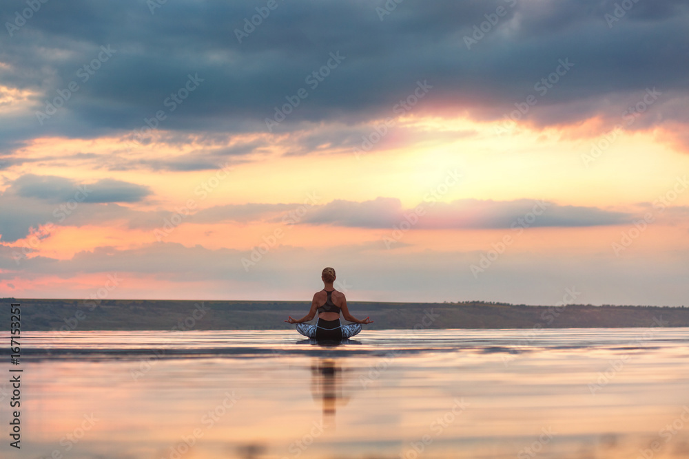 Pretty woman doing yoga at sunset outdoors Pretty woman doing yoga at sunset outdoors