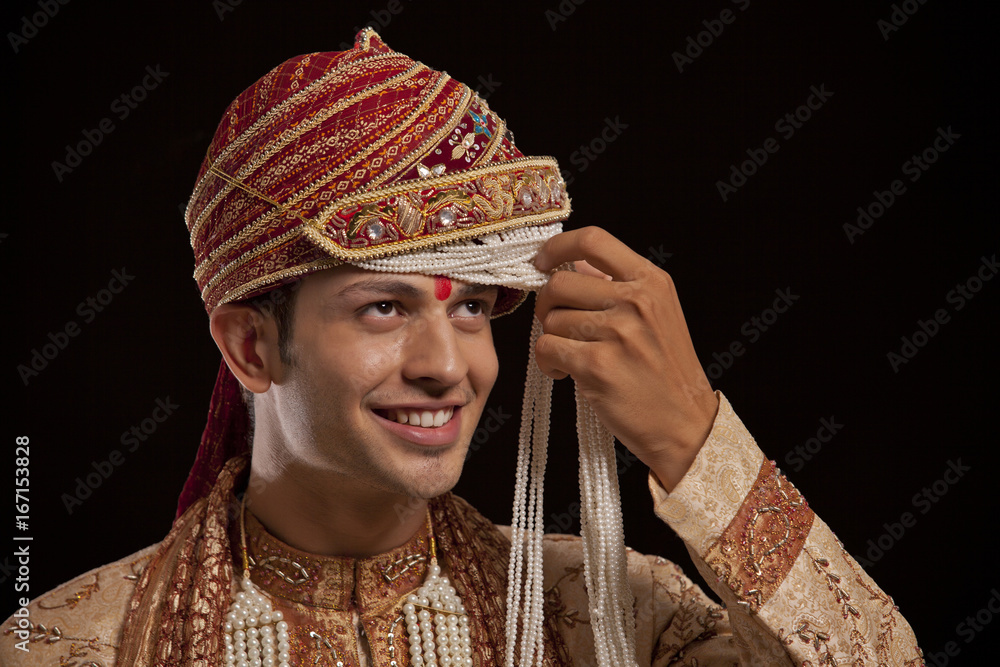 Gujarati groom with a headdress smiling 