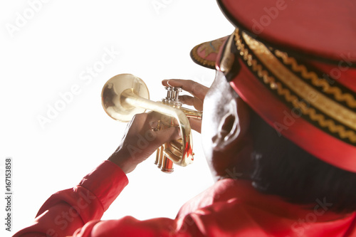 Back view of bandmaster playing on a trumpet