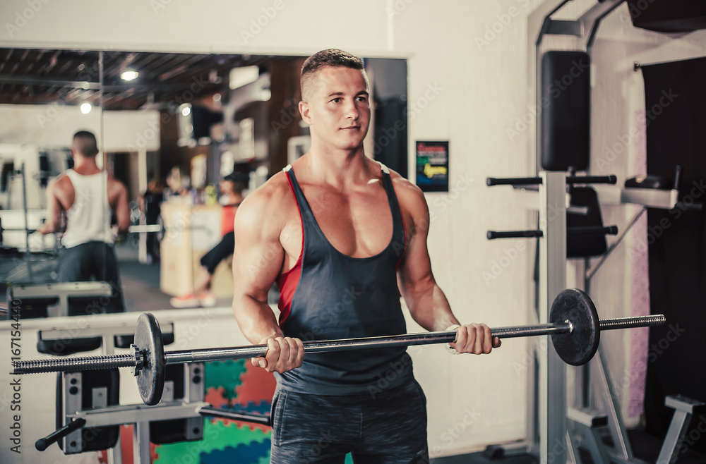 Attractive young muscular man working out his biceps Attractive young muscular man working out his biceps