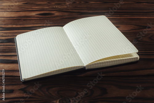 Empty notebook paper on wooden background