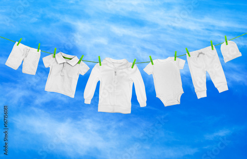Laundry line with light clothes, against the background of blue sky