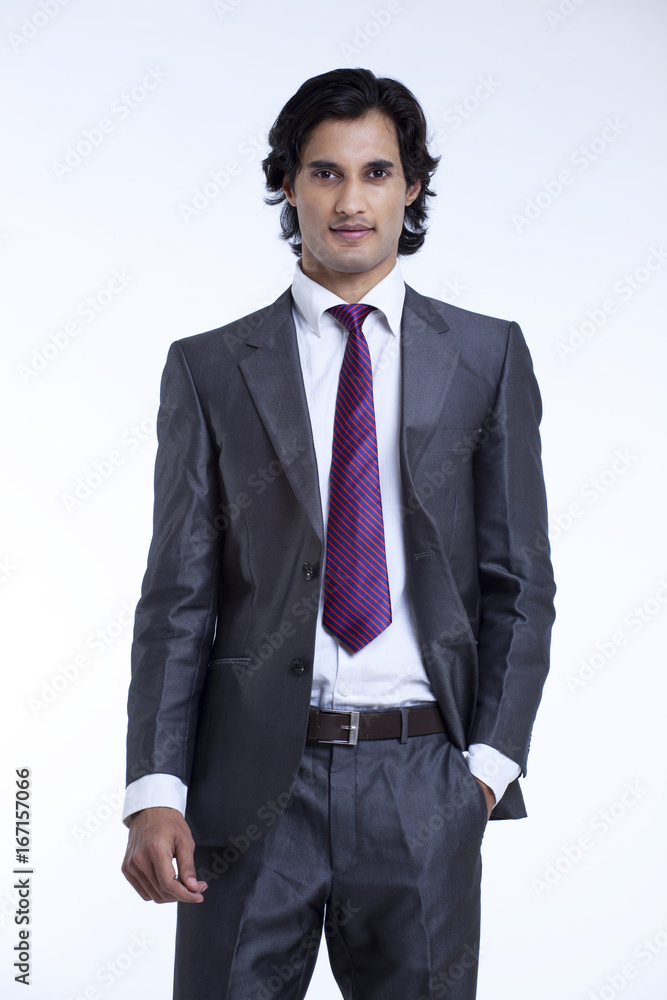 Handsome young businessman standing against white background Handsome young businessman standing against white background