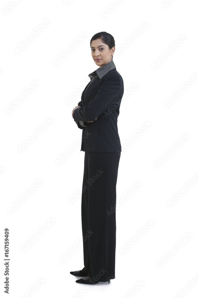 Side view of confident businesswoman with arms crossed standing against white background Side view of confident businesswoman with arms crossed standing against white background