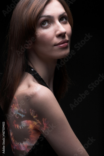 Body-art woman over black background