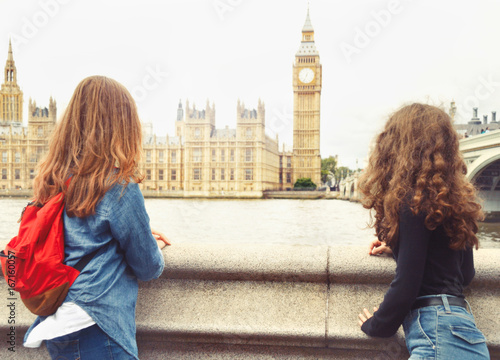 Two trendy teenage girls look at Big Ben, London