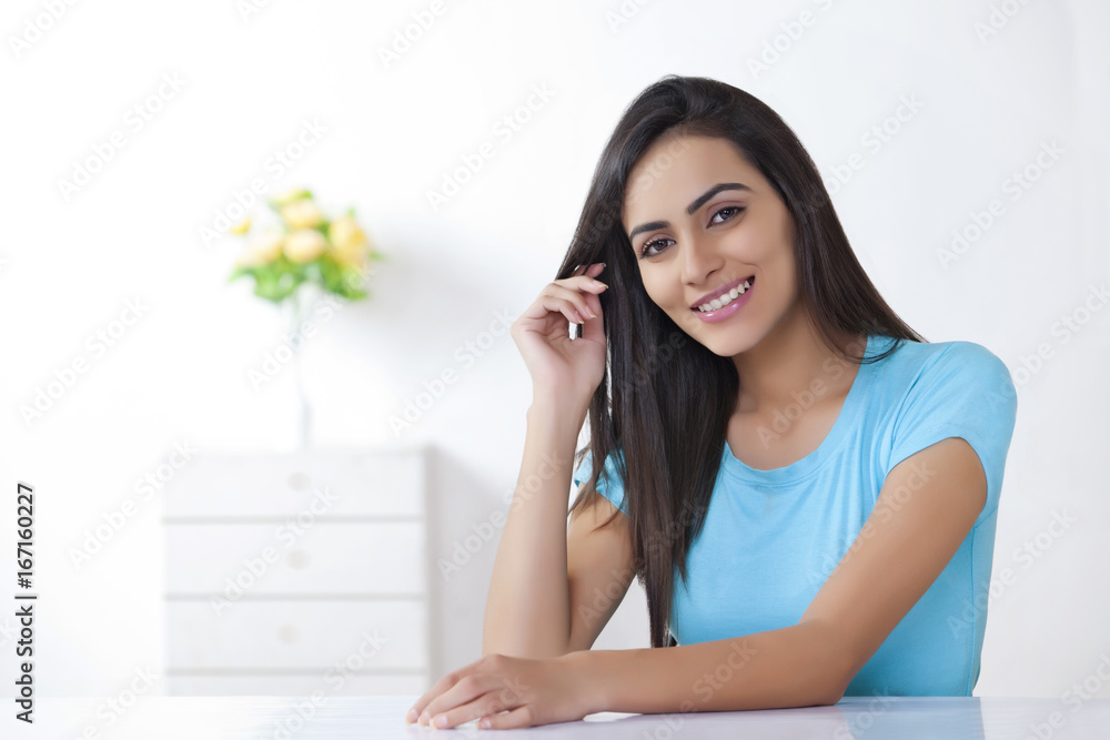 Portrait of beautiful young woman smiling at home Portrait of beautiful young woman smiling at home